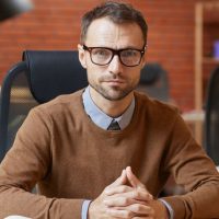 businessman-sitting-at-his-workplace-at-office-1.jpg